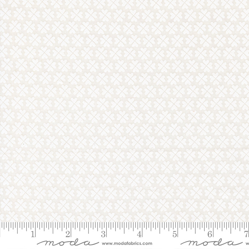 White on white Shamrock fabric pattern with a ruler at the bottom for scale