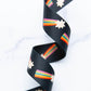 Black webbing with a shooting star and rainbow tail pattern