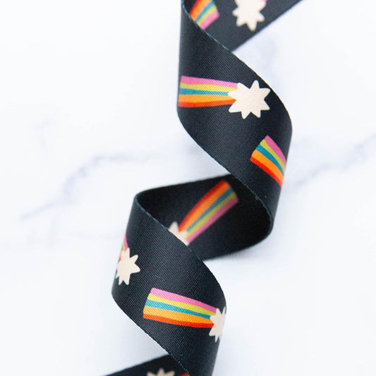 Black webbing with a shooting star and rainbow tail pattern
