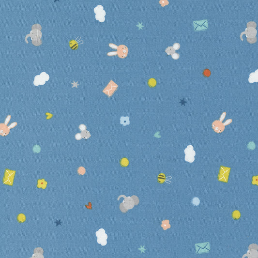 A cotton fabric swatch showing a toss of small animals, stars, circles, letters, and more on a blue background.