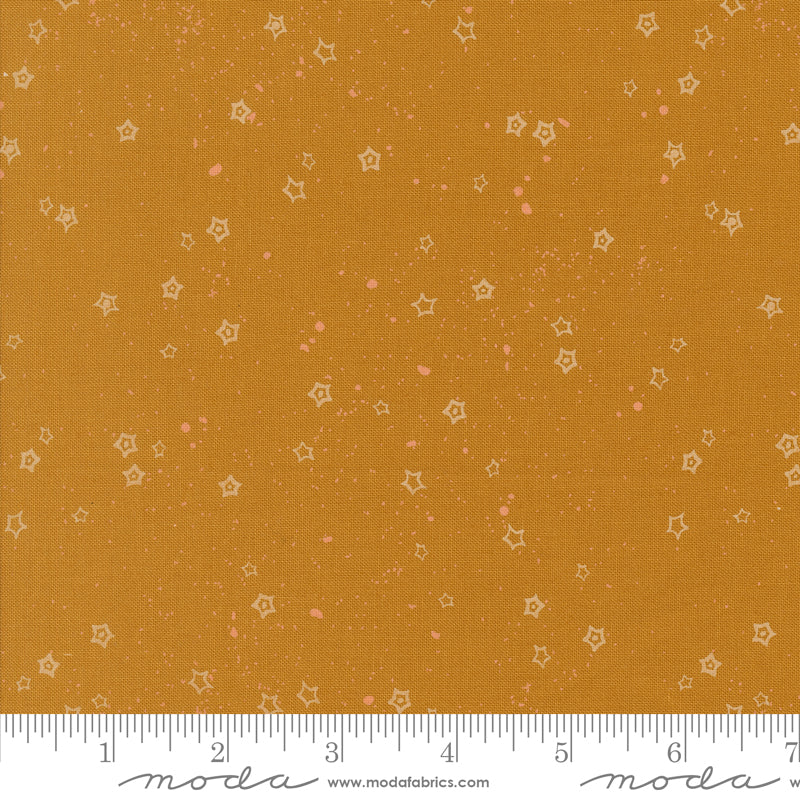 Fabric swatch with star pattern on a caramel background, featuring a ruler for scale and Moda label.