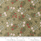 A fabric swatch of quilting cuddle with winter greenery on a light green background with a ruler for scale.