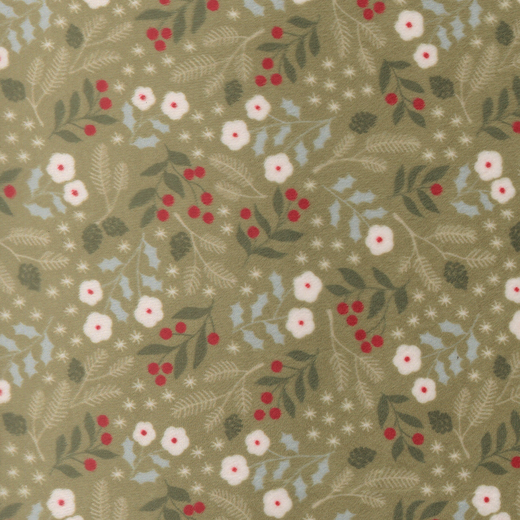 A fabric swatch of quilting cuddle with winter greenery on a light green background.