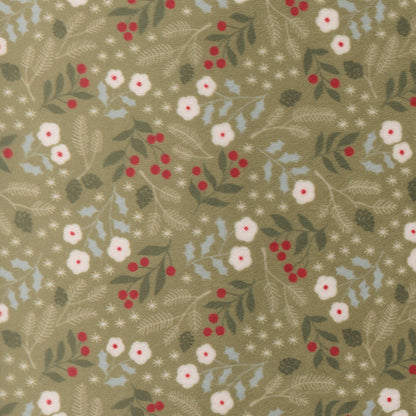 A fabric swatch of quilting cuddle with winter greenery on a light green background.