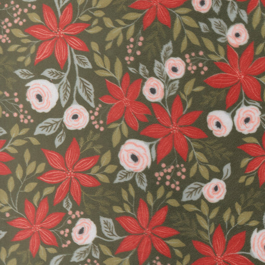 A fabric swatch for quilting cuddle. It has red and white flowers with winter greenery on a deep green background.