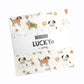 Charm Pack Squares featuring Lucky Fabric by Sweetwater for Moda Fabrics. Label shows the name of fabric and designer.