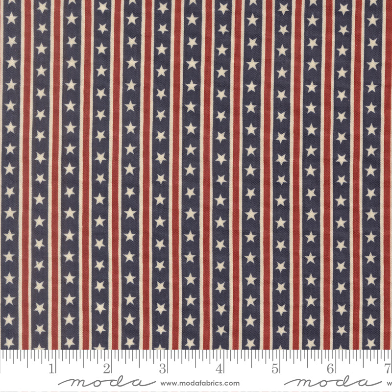 Fabric swatch with a pattern of red, white, and blue stars and stripes. Incldues a ruler for scale at the bottom.