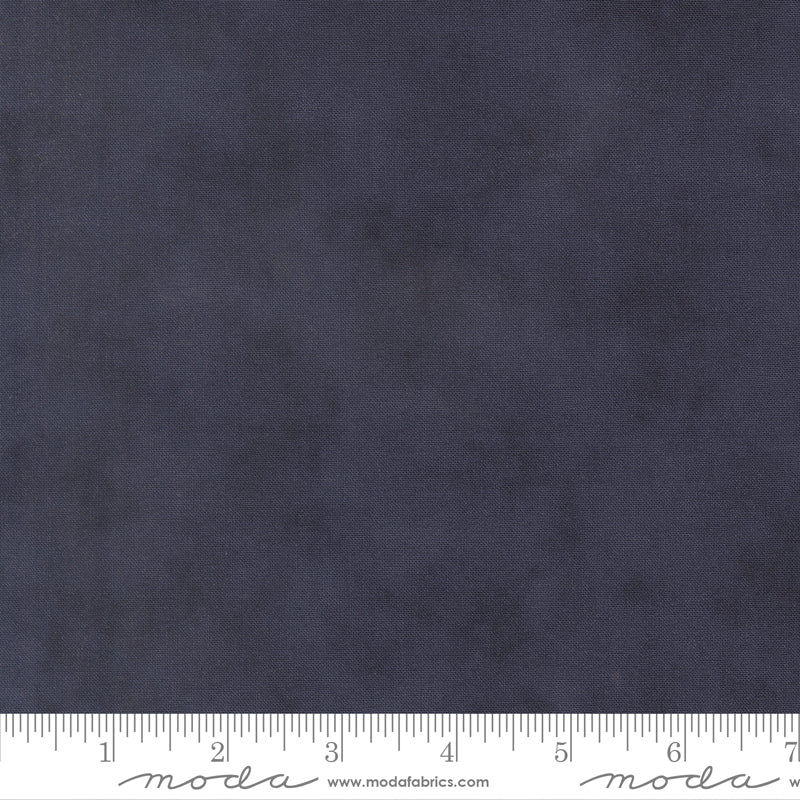 Tonal dark blue color cotton swatch with a ruler for scale
