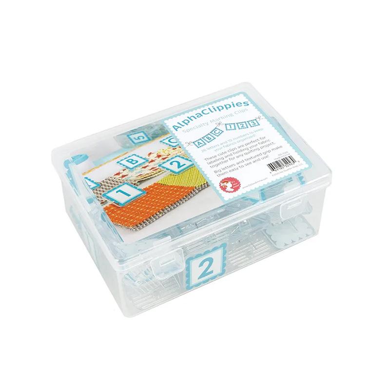 Clear plastic box containing clips with letters and numbers on them and a white background
