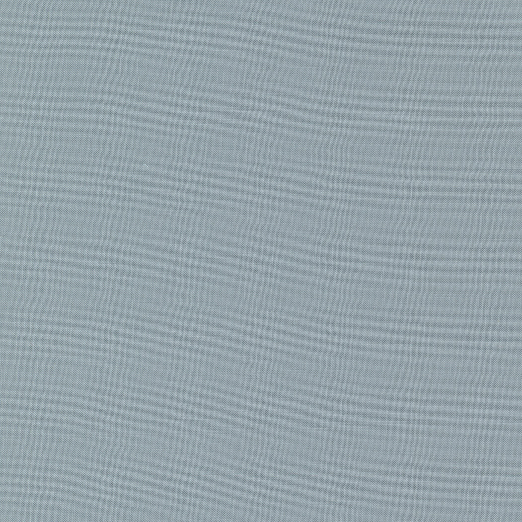 A fabric swatch of a silver solid quilting cotton