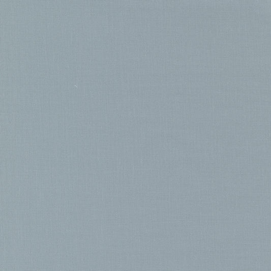 A fabric swatch of a silver solid quilting cotton