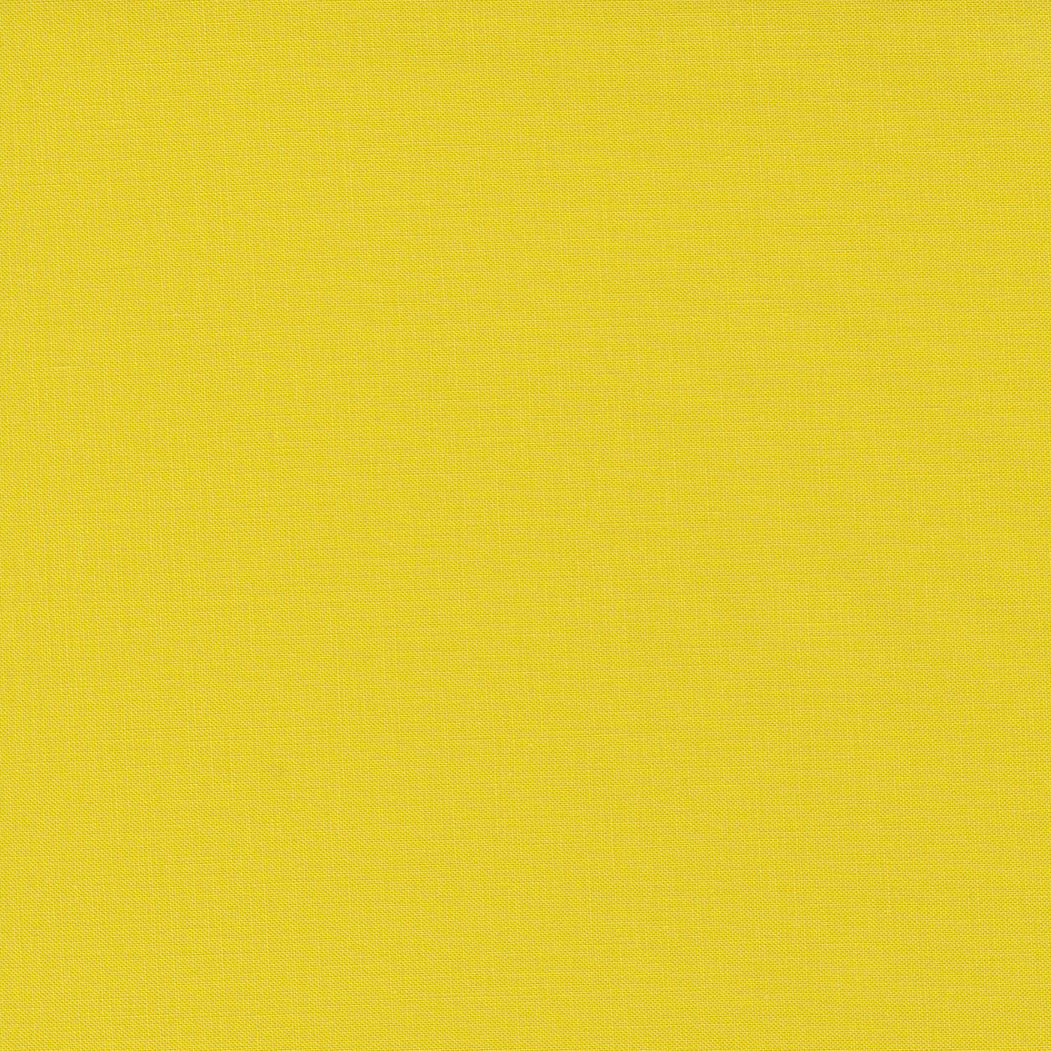 A fabric swatch of a yellow-green solid quilting cotton