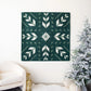 Photo of the finished Artemis quilt hanging on a wall next to an artificial Christmas tree.