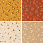 Four fabric swatches. Two in yellow and red with florals and two in white and cream with geometric starbursts.