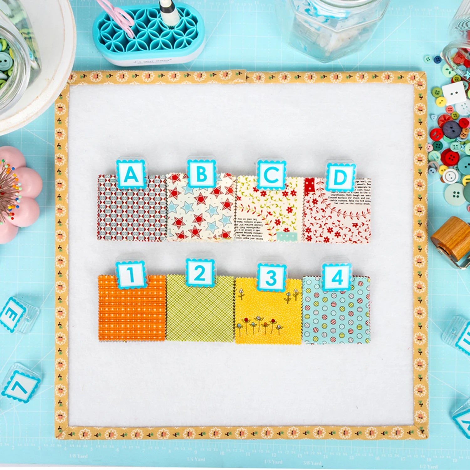A set of fabrics clipped with the Alphaclippies and sitting on a design board.