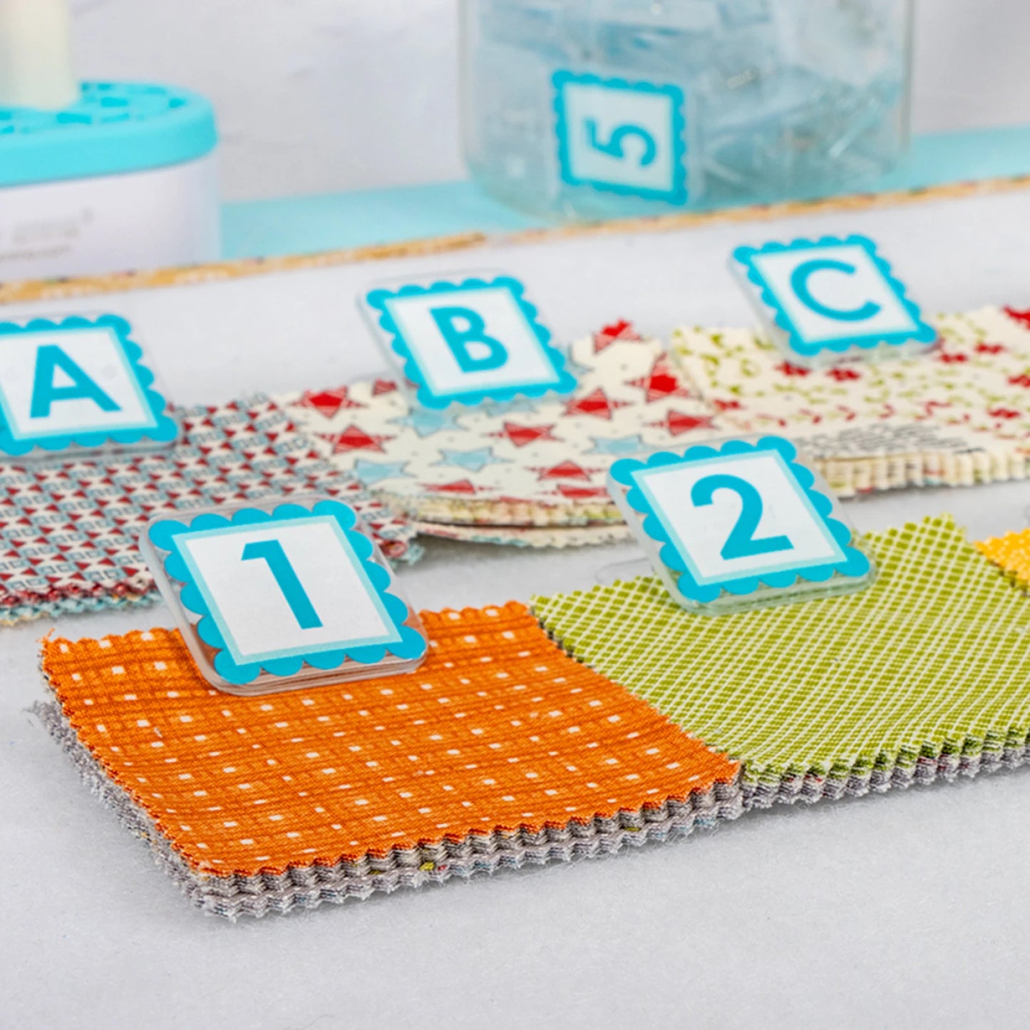 A closeup view of Colorful fabric swatches with clipped with alphaclippies.