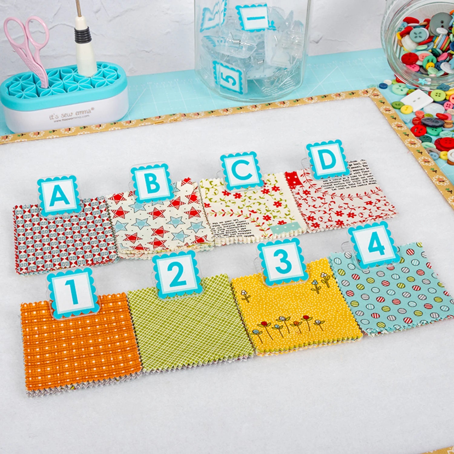 A set of fabrics clipped with the Alphaclippies and sitting on a design board.