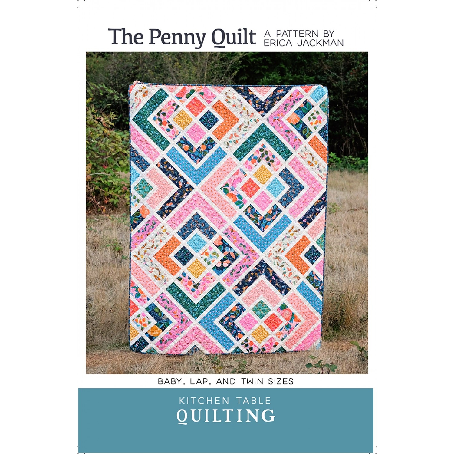 Front Cover the Penny Quilt Pattern by Erica Jackman featuring someone holidng a made quilt in a field