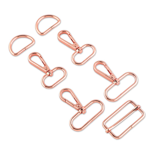 Set of rose gold bag hardware on a white background