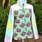 Colorful jacket with floral pattern on a mannequin outdoors.