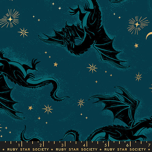 Pattern of dragons and stars on a dark blue background with gold metallic accents and a ruler for scale.