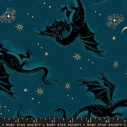 Pattern of dragons and stars on a dark blue background with gold metallic accents and a ruler for scale.