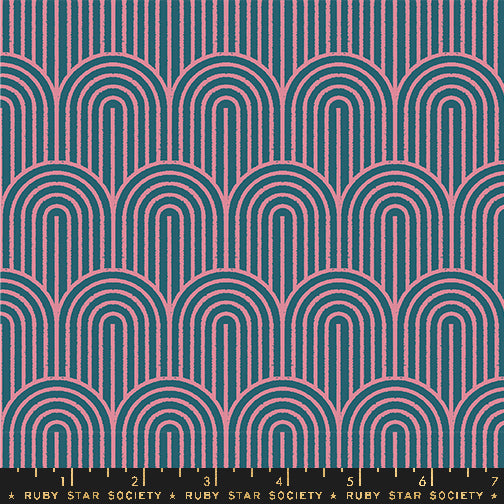 Canvas fabric swatch patterned with arches in pink and dark blue. There is a ruler at the bottom for scale.
