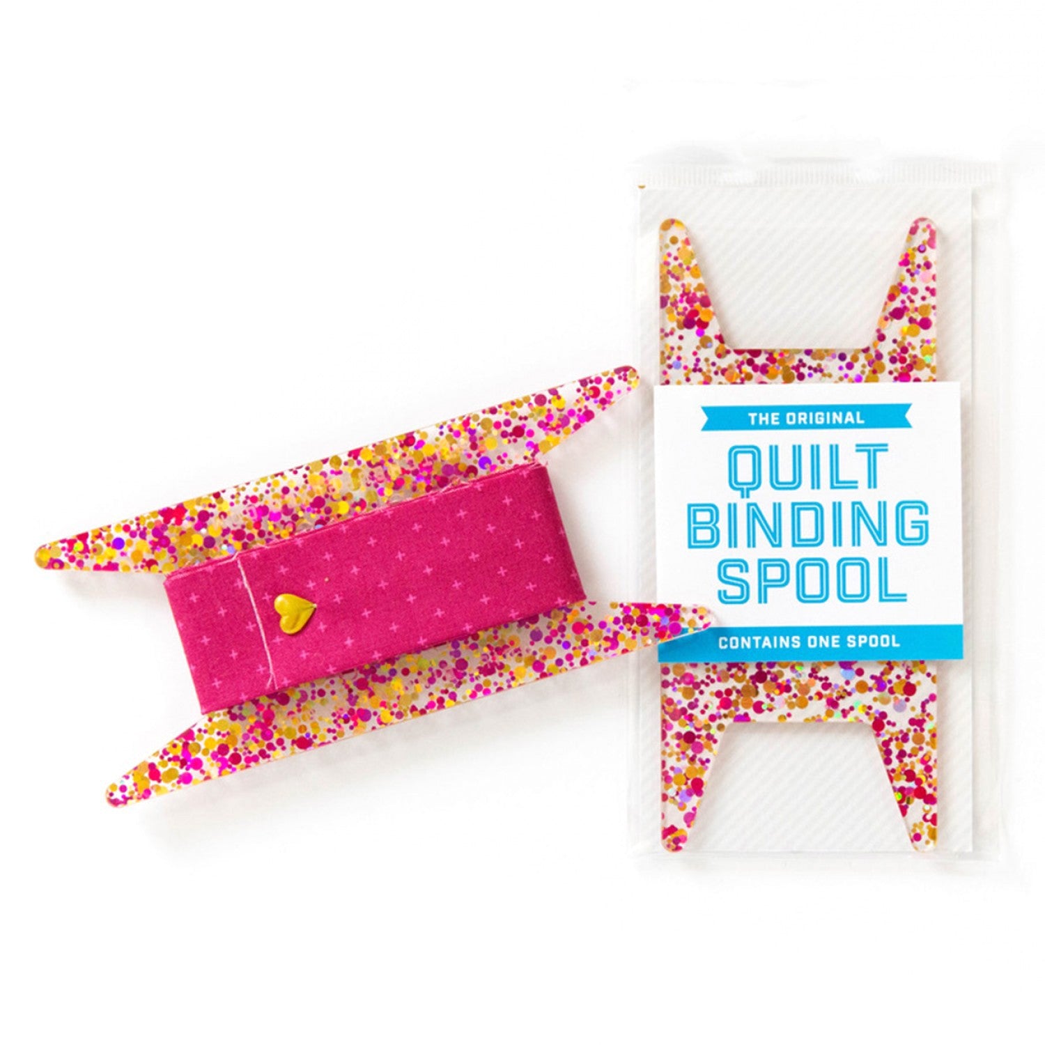 Picture of an acrylic quilt binding spool with pink and gold dots.