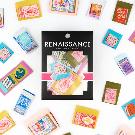 Packaging of Renaissance ribbons colorful sew in quilt labels designed to look like match books on a white background.